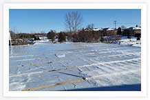 East end with temporary tarping to protect the second and first floors below